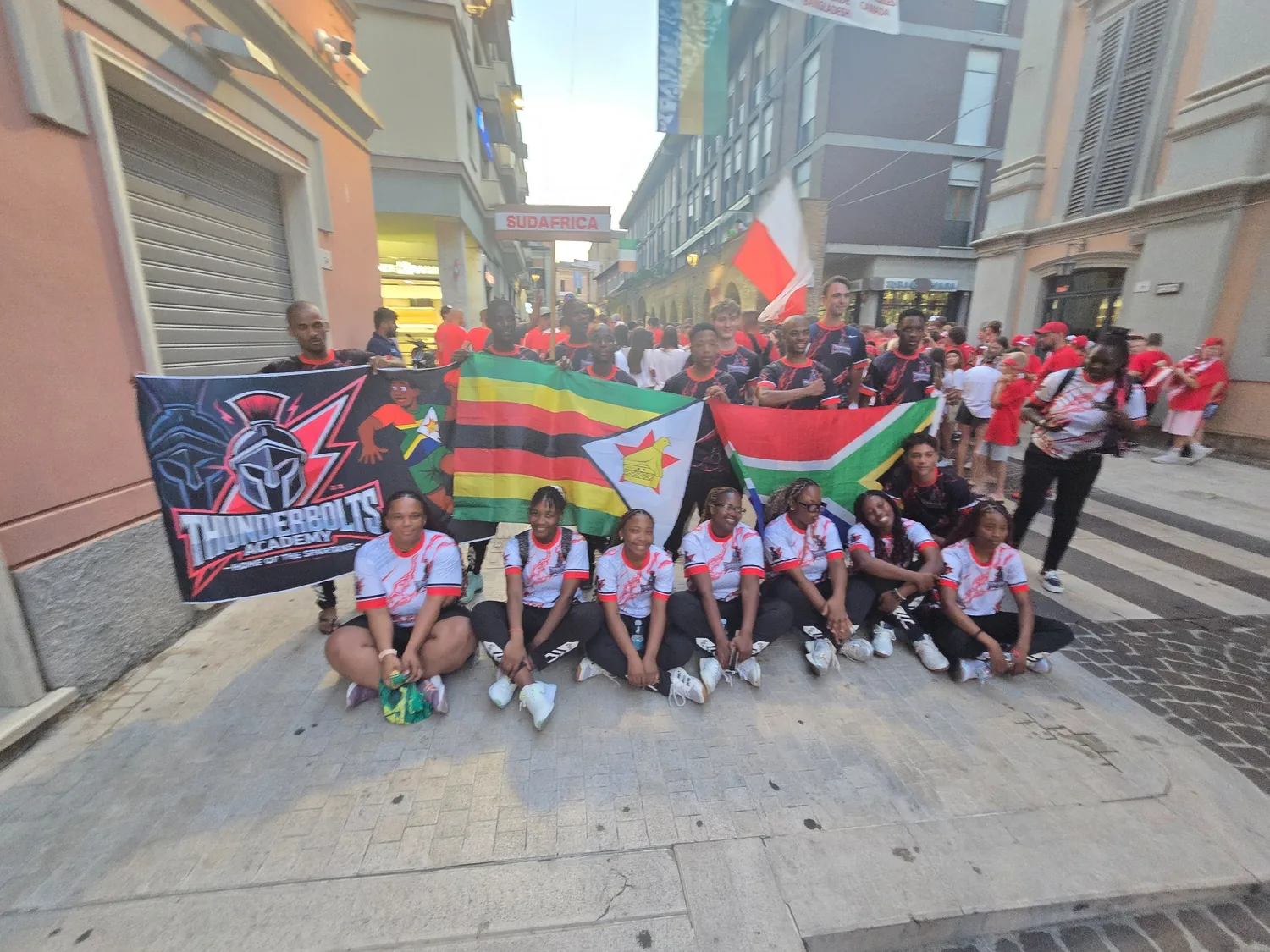 Thunderbolts Academy delegation holding South African and Zimbabwean flags at the Interamnia World Cup in Teramo